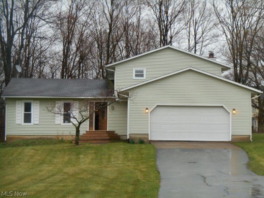 Huge vinyl sided split level set back off the road and resting on just over an acre of property!  Low maintenance vinyl sided exterior…attached two car garage…Large kitchen with raised oak panel cabinets and stainless steel appliances…Cozy family room with fireplace and sliding door access to rear yard…Little paint, carpet and minor repairs could go a long way to earning some sweat equity!