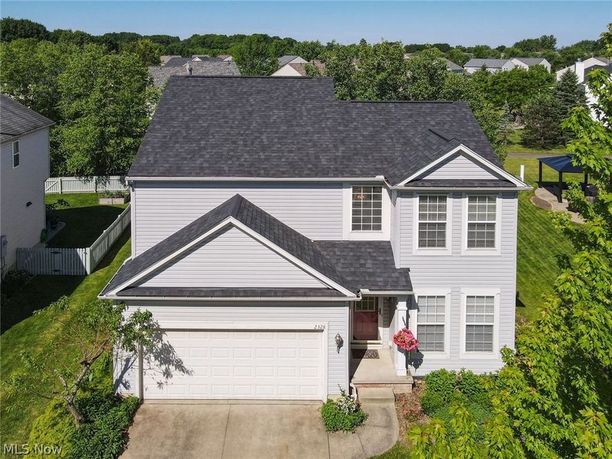 This delightful 3-bedroom, 2.5-bathroom Colonial  is nestled in a fantastic community that boasts walking trails, a playground and park! Upon entering, you'll be greeted by a two story foyer leading to front sitting room + NEW wood laminate flooring throughout the entire home. Vaulted great room includes stunning wall of windows adorned with transom windows, flooding the space with natural light. The heart of the home is the expansive kitchen, complete with upgraded cabinets + center island. The eat-in kitchen offers a versatile space that can be adapted to suit your needs, whether as a dining area, home office, or additional living space. First floor laundry and 1/2 bath complete this fabulous main level! The lovely owner’s suite is a true retreat, featuring a luxurious master bath and a generous walk-in closet. Two additional bedrooms share spacious hall bath. Finished family room in the basement is perfect for entertaining and additional living space. Step outside to the stamped concrete patio, surrounded by beautiful landscaping that ensures your privacy while you enjoy outdoor gatherings or quiet relaxation. For those who love outdoor activities, the walking trails in the community seamlessly connect to the Metro Bike & Hike trail. This charming home is a perfect blend of comfort, style, and convenience in a community that has it all. Don't miss the opportunity to make it yours! Updates include: NEW ROOF (2020), AC (2018), ALL NEW FLOORING, SUMP PUMP, RADON MITIGATION SYSTEM (2019), LANDSCAPING AND MORE!