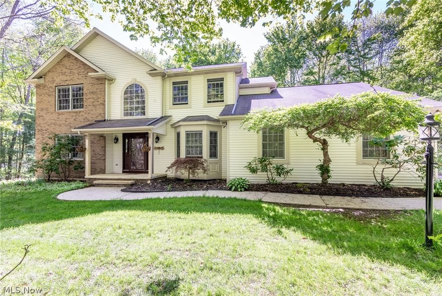 Tucked away on four beautifully wooded acres, this 4 bed, 2.5 bath center hall colonial offers plenty of privacy in a wooded wonderland! Enter through the front door and into the two-story foyer, with the bright and inviting living room to one side, and dining room on the other. The spacious kitchen features an eat-up island, pantry, informal dining, and opens to the family room, which has a raised hearth wood burning fireplace. It is perfect for relaxing or entertaining family and guests! The main floor is complete with new commercial grade porcelain flooring (2018), first floor laundry, updated bath room, and access to the attached three car garage. The second-floor master offers two closets, one of which is a walk-in, and large master bath with a soaking tub. Three additional bedrooms are located on the second floor, two of which offer walk-in closets, and an updated full bath in the hall. The lower level is ready to become a playroom, media room, gym, or whatever you may need! Addi