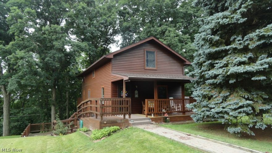 Beautiful 7+/- acre hilltop country setting!  3 bedroom, 2.5 bath redwood and cedar home.  Neutral decor.  Hardwood floors in the living room and dining room.  Oak kitchen with island breakfast bar.  Soaking tub with ceramic tile surround in the second floor bath.  Walk in closet in the master bedroom.  Finished walk out lower level leads to the 18 X 13 covered deck.  Anderson windows.  Spacious wrap around deck with beautiful wooded views.  Exterior freshly stained in 2014.  New roof in 2015.  $2,000 central air allowance, $400 dishwasher allowance.  26 X 34 garage with electric.  Over sized (28 X 24) 2 car garage.  50 X 30 pole building with 2nd floor storage area.  16 X 8 playhouse.  1981-3 bedroom, 1 bath mobile home currently rented brings extra income.  Seller to reserve all lease income from the cell phone tower.  Excellent country location with easy access to town.