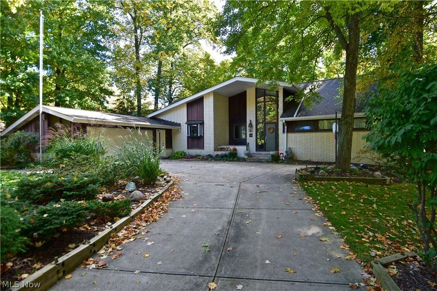 Rare opportunity to own an exceptional property bordering the Cleveland Metropark Rocky River Reservation! Quiet, secluded location at the end of the Valley Forge cul-de-sac. Fabulous layout offers many possible furniture arrangements. Rooms are spacious, as well as the entry foyer with high ceiling. Unique features include dual fireplace that warms the first-floor family room, kitchen, and living room; updated mudroom with efficient storage systems; open, curved staircase to second floor. Soaring windows let in much natural light and great views. First-floor master bedroom and full bath. First-floor bonus room, currently used as a bedroom, has many potential uses. Updates include some newer wood flooring; kitchen remodel with beautiful finishes including limestone floor, upgraded appliances and extras; light fixtures; freshly painted throughout. Wonderful finished basement with wet bar and multiple rooms--pool room, rec room, playroom, laundry room, workshop, full bath. Incredible sto