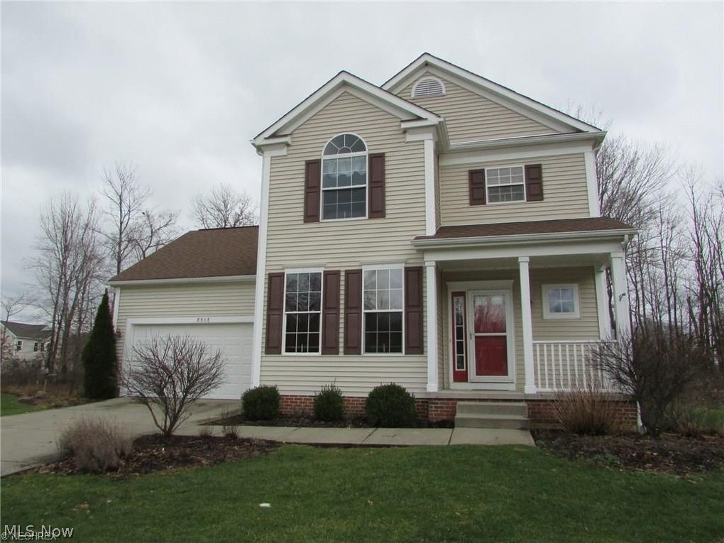 Beautifully maintained and enhanced colonial in desirable Whispering Woods neighborhood. Situated on the "bubble" and surrounded by common area, this nearly maintenance free home overlooks a wooded area to the back, providing privacy when entertaining on the large deck (16x12) and paver patio. The covered front porch (11x6) offers protection for your guests from inclement weather, and is perfect for sitting and visiting with the neighbors. Hardwood flooring flows from the generous foyer and half bath through the dining room and great room. The dining room features 2 large windows, a trayed ceiling and crown molding. The great room offers a gas fireplace flanked by windows and a wall of windows overlooking the back yard. The upgraded kitchen overlooking the great room is highlighted by maple cabinetry, granite counters, tile flooring and a large eating area with bay window and slider to the deck. Off the kitchen is a generous laundry room w/tile flooring. The turned staircase leading to