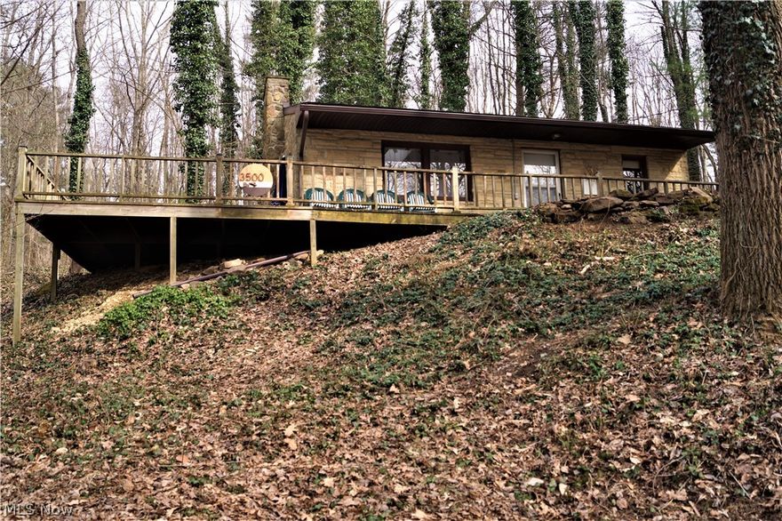 Nestled in the woods on a two parcels of land you'll fall in love with this cozy 2 bedroom, 1 bath cabin in Rockwood Park at Leesville Lake. The extra large deck along this stone cabin provides lot of space for family and friends! Start a fire in the inside fireplace or the outside fire pit on cooler nights. All new laminate flooring throughout in March of 2021. New vanity, mirror, and toilet in March 2021. New tankless hot water heater in March 2021. Everything is sparkling clean, exterior power washed and interior freshly painted. Roof is approximately 10 years old.  List price includes a third parcel across Rockwood Dr. gives you  short walk to the lake where you'll enjoy 1000 acres of boating, fishing, and swimming! Beautiful Leesville Lake is known for some of the greatest muskie fishing around! Rockwood Park is known as a quaint private community with a private beach and private docking.