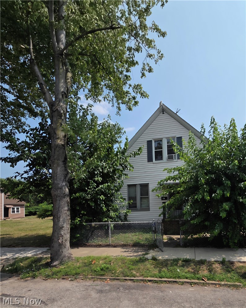 Bungalow-style home with a fenced front yard and a gate