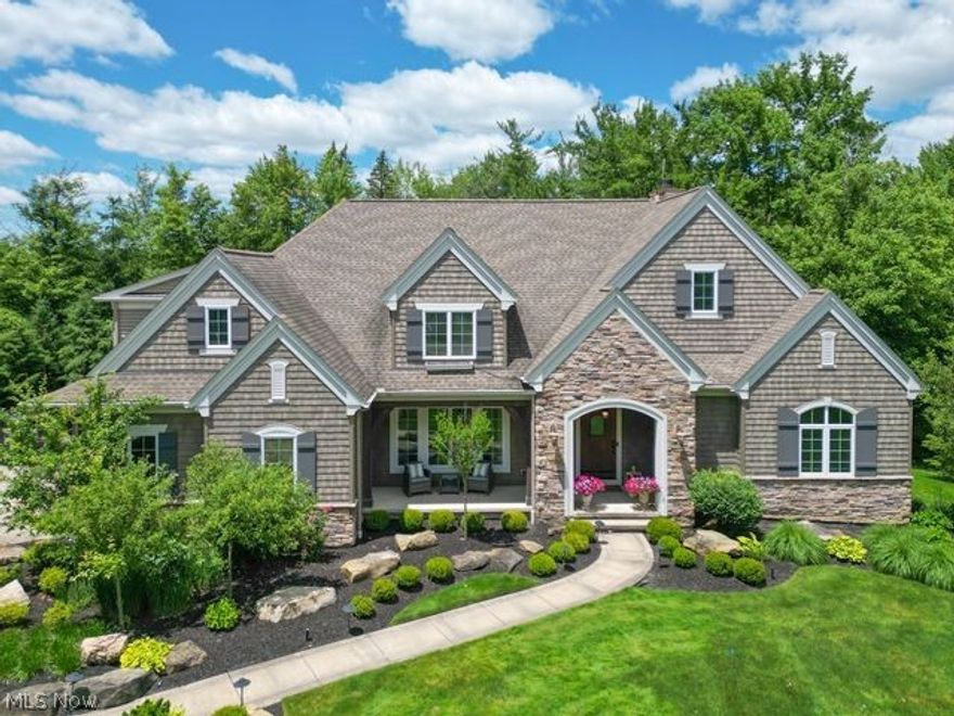 Situated on a tranquil, 1+ acre lot, this exceptional newer build offers an abundance of space, top of the line finishes and quick access to shops, restaurants and award winning schools. Mature landscaping and large lot open to the covered front porch. As you step inside, you are greeted by a spacious entryway that leads to a private office and formal dining room with windows looking on to the exterior. The white and bright great room includes charming built-ins, beamed ceilings and fireplace. Expansive kitchen features marble countertops, massive kitchen island, SubZero refrigerator, Wolf cooktop, Wolf double oven, Viking beverage cooler in butler’s pantry, additional walk-in pantry, reclaimed wood on ceilings and welcoming eat-in area. The additional family room is adorned with a stone surround and fireplace. Unique and beautiful four-season room is filled with an abundance of windows and offers the perfect space for relaxation. The home also includes a large screened-in porch, ideal for enjoying the outdoors in comfort. Hallway off the kitchen provides convenient access to a mudroom, garage and half bath. On the second floor, you will find four spacious bedrooms, three full baths, landing area for homework/additional recreation space, laundry room with granite countertops and new carpeting throughout the entire level. The owner’s suite is a true retreat, featuring a massive walk-in closet and an en-suite glamor bath with dual vanities,  soaking tub, and walk-in shower. The lower level is an entertainer's dream, complete with a large living room, movie theater, workout space and half bath. Outdoor living is equally impressive with a back patio and porch, perfect for enjoying warm weather and hosting gatherings. This home offers a perfect blend of elegance, comfort, and functionality, making it an ideal place to call home! Custom built with no detail overlooked. BONUS Chagrin Falls schools + Geauga taxes. See supplements for updates list and more!