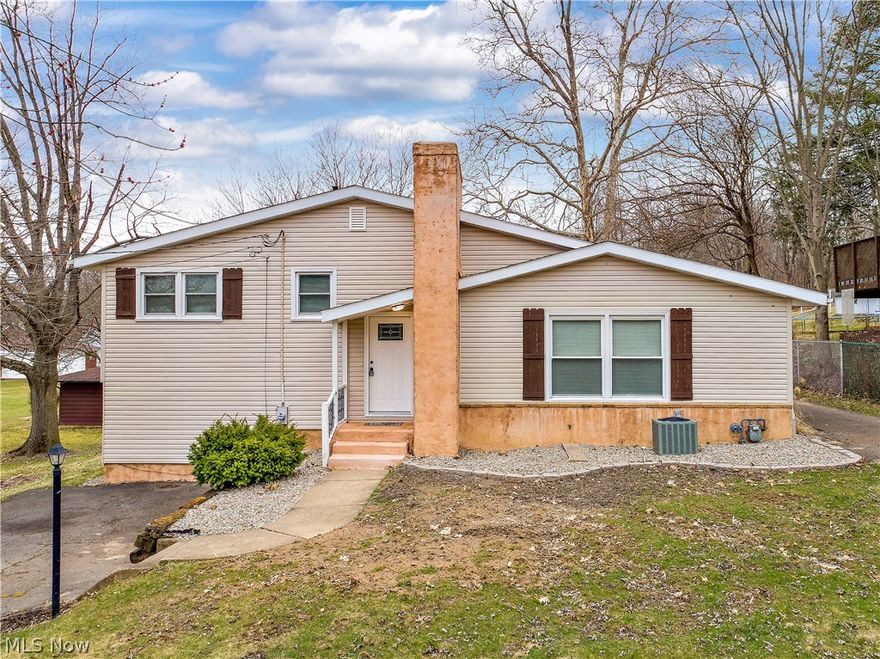 Spacious 4 bedroom, 2.5 bath with progressive floor plan featuring an awesome mid-level master suite.  Master bath with double sinks and Whirlpool jetted tub. Laundry room/1/2 bath conveniently located directly across the hall from the master. Three bedrooms and a full bathroom upstairs.  Updated kitchen with granite countertops, beautiful refinished original hardwood floors in Livingroom with woodburning fireplace . 2020 updates include, brand new deck, kitchen sink, 3 new toilets, all new plumbing fixtures, front door, carpeting, garage door openers (2) and utility door to the EXTRA 2-CAR OVERSIZED DETACHED GARAGE. 2011 Updates include, roof, siding, windows, HVAC, 50 Gal.HWT, 200 amp electric. Just Fabulous!