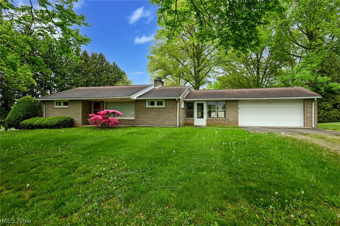 Welcome to 1960's perfection! This classic brick ranch has all the great retro features of it's era. Sitting atop a touch more than an acre lot in the beautiful Sandy Valley. Enter through the huge enclosed breezeway , where you can sit and swing for hours enjoying the peace, quiet and views of the yard. Into the kitchen you will be in aw of the tile work, mint condition appliances, groovy countertops and backsplash and brick accent wall. Plenty of space for a full size table or utilize the back portion of the great room as the formal dining area. This wide open space is filled on both sides with amazing natural light! Be sure to take a closer look at the sparkling stone surrounding the wood burning fireplace too! Off the hall are two large bedrooms. The perfect condition of the red and blue carpeting is the tell of how immaculately this one owner home has been cared for! The bonus is that there is untouched original hardwood floors under the carpet in the bedrooms! You will once again be blown away by the incredible tile work in the main bathroom. The great news is retro is IN. So this perfect pink bathroom won't need a thing! Before heading downstairs, don't miss the large laundry room/ half bath with amazing storage. The lower level features a huge rec room with another wood burning fireplace! On one side there is a large shower with lots of storage area, then on the opposite side is an even bigger open storage/workshop area. All of this in such a wonderful location, tucked between East Sparta and Magnolia. You'll be sad if you let this one slip by, so CALL TODAY!
