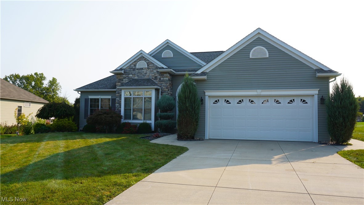 Look at this wonderful opportunity in Brimfield Township. Located in Country View Estates, this 2,068 sq. ft. Ranch built in 2015 with walk-out basement is set on rolling terrain creating a private setting with fabulous vistas. From the road, you’ll notice the stone veneer accents and beautiful landscaping. As you enter the home through the covered front porch, you are welcomed into a spacious entry way with 13’ high ceilings and ceramic tile flooring. To your left, French doors frame a sizable bedroom that could also serve as an office or library. High ceilings in the room create a voluminous effect. As you move through the home, a massive Great Room with rustic wood burning fireplace awaits just beyond the entryway. Freshly laid carpet flows throughout the space and leads you through the open floor plan connecting seamlessly to the home’s formal dining area. The dining area is strategically located between both the Great Room and Kitchen and hosts a peninsula style breakfast bar for your less formal dining occasions. The fully equipped Kitchen is graced with a trendy corner pantry closet, maple cabinets and solid surface countertops. Conveniently located just down the hall from the kitchen, you’ll find your main floor laundry along with basement and garage access. Rounding out the living space is a stunning Sunroom with cathedral ceilings, natural sunlight and sliding door access to a screened-in porch with views of the private pastures behind the home. The primary bedroom along with a second bedroom and bathroom are located privately towards the back of the home. The over-sized bedroom suite is adorned with a decorative trayed ceiling. A generous walk-in closet and en suite bathroom with low threshold shower, dual vanity and linen closet provide additional amenities. Below grade, a cavernous partially finished basement is plumbed for future finishing and has French doors that walk out to a private stamped concrete patio. Don’t miss your chance to see this gem!
