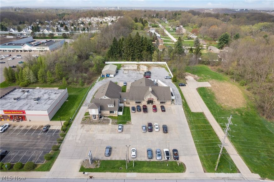 Investment Opportunity in Tallmadge! This almost 8,000 sqft building is situated on just under two acres and features a long-standing anchor tenant, Sammie's Bar and Grille. To the left of Sammie's, there are currently 4 divided spaces (which was one large space at one time and can easily be brought back to that), 3 of which are occupied. There is currently a 2,500 sqft space (currently built out as an office) available for immediate occupancy.