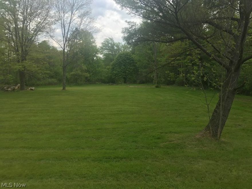 NEW PRICE!! Beautiful spot to build on Music Street ! 5 acre buildable parcel. Deep flat wooded lot - area cleared for building.  Previous home removed with utility lines from the street for gas and electric.  New septic system will need to be installed.  Aluminum red barn on property in "as is" condition.  Close proximity to Chagrin Falls and easy access to 87 and downtown.  Russell Township.  Excellent place to build your new dream home!