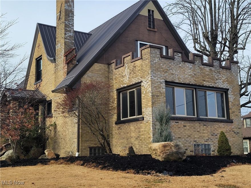 Come view this property, bring your ideas and make it your own!!! Large , 2 story brick home.  Great corner lot. There are 4 spacious bdrms, one currently used as an office, and 2 full baths, 1 up and 1 on main.  Original woodwork through out as well as numerous built ins in living room and dining room and mostly hardwood floors, all well maintained.  Living room has functional, gas fireplace. per seller. Mud room was added on rear for main floor laundry convenience and 4 season room added on front.  This is the perfect place to enjoy your morning coffee or to watch it snow while reading that book.  Bring your ideas and transform this home to your desire.  Windows, metal roof have been updated. There are remote control awnings as well as newer concrete side walk and patio areas. There is a park to the rear of the home that's perfect for children and grandchildren. Basement is full, unfinished with walk out. Sells "as is - where is" with buyer right to inspections.