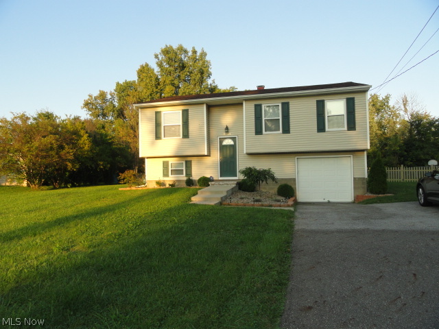 Must see inside! Complete renovation in 2011. Beautiful cherry kitchen, granite counters, stainless finished appliances and cushiony cork floor! Updated bathrooms including ceramic floors. Spacious living room plus lower level family room. 4 bedrooms, 2 full baths! Sliders to 12 x 12 deck porch overlooks huge fenced backyard. Updated furnace, c/a, siding and carpet. Large bright laundry room. Extra parking pad for convenience. Don't wait!!