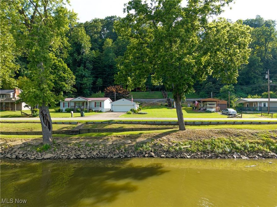 Scenic Muskingum Riverfront Retreat – 3 Bed, 2 Bath Home with Boat Access and RV Hookups. This is a rare opportunity to own a riverfront property on the scenic Muskingum River, offering year-round comfort and an unbeatable lifestyle on the water. This charming 3-bedroom, 2-bath home features 1,188 square feet of living space and sits on approximately 178 feet of river frontage—ideal for mooring your boat, kayaks, or jet skis. Relax to the peaceful sound of water rushing over the historic Devols Dam, just beyond your backyard. The functioning locks at the dam provide boating access downstream to the Ohio River, giving you endless opportunities for recreation or North on the Muskingum River. Behind the home, a private stairway leads to a hilltop picnic shelter with breathtaking views of the river—perfect for morning coffee or evening sunsets. An added bonus is the concrete pad/pavilion with full RV hookups including a 1987 camper, ready for visiting friends or to generate extra rental income. Whether you're looking for a relaxing getaway, a fishing and boating haven, or a cozy full-time residence, this riverfront gem offers it all. Schedule your private showing today—properties like this don’t come along​​‌​​​​‌​‌​​​‌‌​​​‌‌‌​​‌​​‌‌​​​​ often!