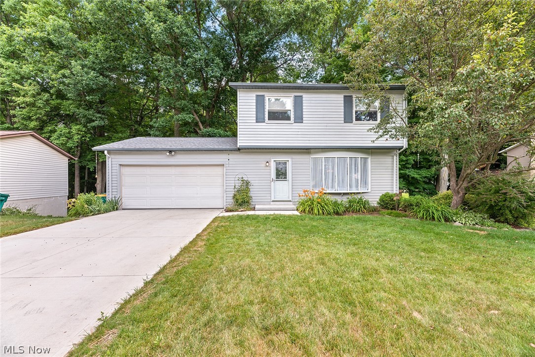 HURRY, you WON'T want to miss the opportunity to own this beautifully updated colonial on a wonderful treed lot w/your own private walking path to Tinker's Creek right in your backyard!! From the moment you pull into the driveway you'll notice the fabulous curb appeal this home has! With a newer (2021) concrete driveway, garage concrete floor, and lush landscaping! Entering the home, you'll find a spacious living room featuring a large window to allow lots of natural light in, a nice sized formal dining room, both w/updated hardwood flooring! Dining area has door that leads to upper deck (2015), perfect for enjoying dinner or the peaceful backyard on a summer's evening. Kitchen is updated with all the bells n whistles: new cabinets, stainless steel appliances, backsplash, gorgeous granite, recessed lighting, ceramic tile PLUS a convenient pantry! First floor 1/2 bath as well! Upstairs you'll find three generously sized bedrooms and a full updated bath w/double sink vanity, medici