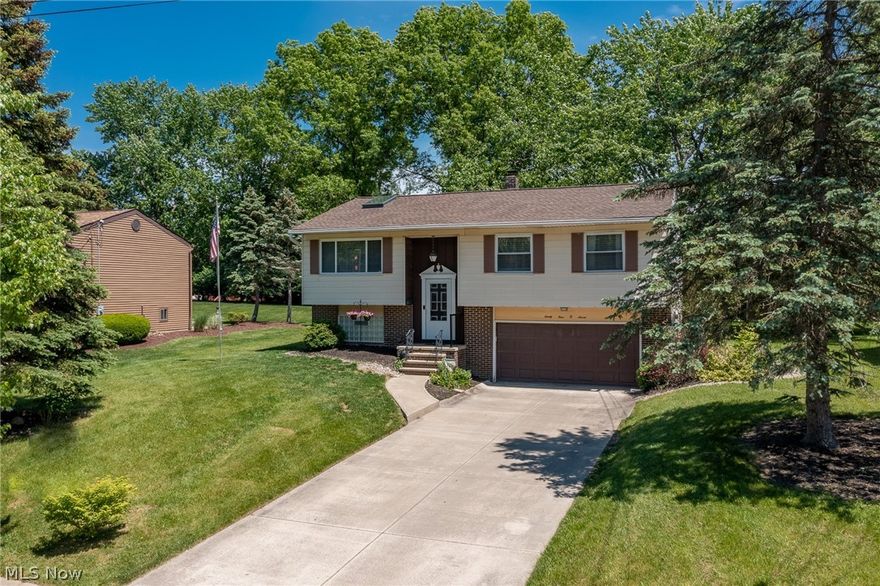 This gorgeous bi-level will be sure to check all of your home search boxes!  Move right in to this well-maintained, 3 bedroom 2 full bath home!  Enter through the front door to be greeted by large, vaulted ceilings, with skylights and exposed beam.  Large open family room with lots of natural light, flows right into large and open dining room.  Sliding door off dining room leads to a large deck overlooking a large and private backyard.  Deck leads to oversized cement patio for additional space and entertaining on those gorgeous summer nights.  Kitchen has brand new floors, lots of cabinet space and countertops, and stainless steel appliances. All 3 bedrooms located upstairs with a large full bath.  Lower level adds ample space for a bonus room, living area and/or office space.  Laundry area located downstairs with updated mechanicals, and an additional full bath!  Attached garage with plenty of space for parking and storage completes this wonderful home.  If you're looking in the award