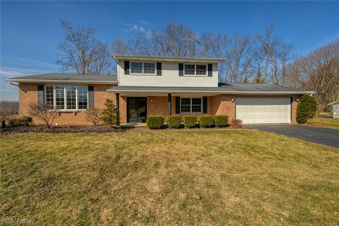 This Hartville home has it all, 3 or 4 bedrooms (utilizing the bonus room), living room and family room and 3 car garage or 2 car plus an amazing workshop! Enter in through the new energy efficient Provia double doors, into the large foyer. You will immediately notice the gorgeous bamboo floors in the living room. This room is wide open and soaks up all of the natural sunlight through the, nearly floor to ceiling bay window. Continue into the formal dining room, which also features the bamboo flooring and new lighting. The kitchen also basks in the bright sunlight from another bay window with seating/display area. No broken dishes with the shock absorbent cork floors! This kitchen provides tons of cabinet space, including a lazy susan, tile backsplash, all appliances included and open to the family room. The woodburning, brick fireplace and access to the sunroom, makes the family room the place to be. The sunroom features a set of sliders from the family room, plus 3 more to k