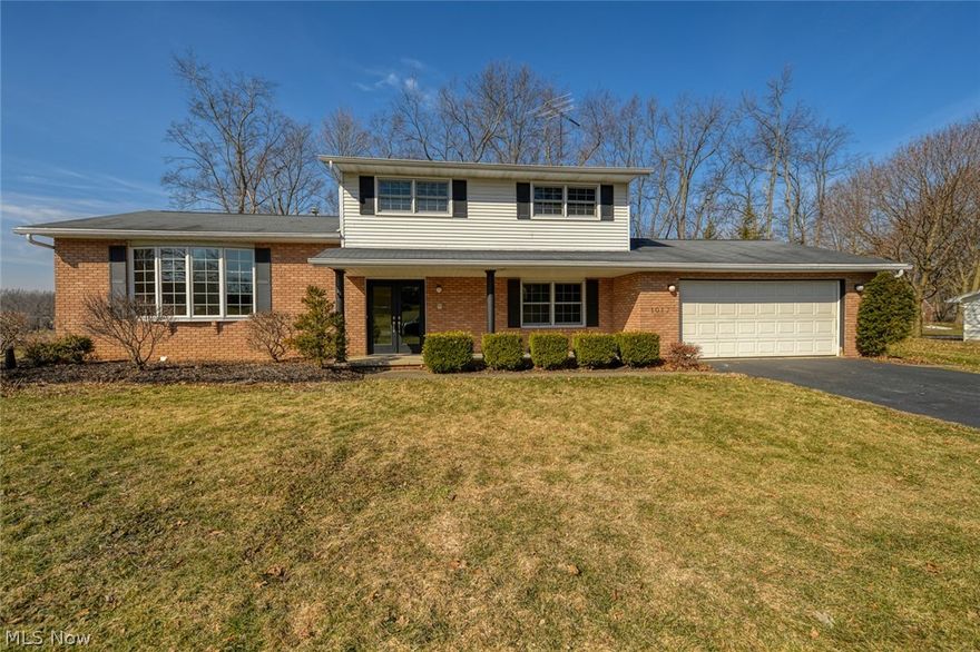 This Hartville home has it all, 3 or 4 bedrooms (utilizing the bonus room), living room and family room and 3 car garage or 2 car plus an amazing workshop!  Enter in through the new energy efficient Provia double doors, into the large foyer.  You will immediately notice the gorgeous bamboo floors in the living room.  This room is wide open and soaks up all of the natural sunlight through the, nearly floor to ceiling bay window.  Continue into the formal dining room, which also features the bamboo flooring and new lighting.  The kitchen also basks in the bright sunlight from another bay window with seating/display area.  No broken dishes with the shock absorbent cork floors!  This kitchen provides tons of cabinet space, including a lazy susan, tile backsplash, all appliances included and open to the family room.  The woodburning, brick fireplace and access to the sunroom, makes the family room the place to be.  The sunroom features a set of sliders from the family room, plus 3 more to k