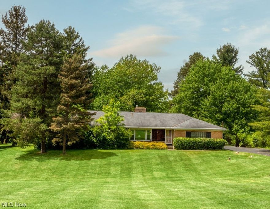 Welcome home to this sprawling brick ranch centered on almost 2 acres on highly desired Westchester Trail in Chesterland. 2000 square ft with 4+ garage spaces and workshop, with 220V and a furnace. Classic 1960 design with a wrap around fireplace. Hardwood floors in closets indicate most likely throughout the main living areas and bedrooms.  Bonus room off the dining room has a separate entrance directly to the garage. Large eat in kitchen leads to a 34' x 10'  three season room (breezeway). The bedrooms are nice sized, Bedroom 1 & 2 have walk in closets. Master bedroom has double closets and an en-suite bath with walk in shower. 
Full basement is partially finished, and laundry hook up located here. The yard is a nature lovers oasis and a Birdwatchers delight! This home has been lovingly maintained by the same family for many years. It is now ready for the new owner to make it theirs. A great place to make lasting memories. 1/2 mile south of Mayfield Rd (route 322). Easy access to ho
