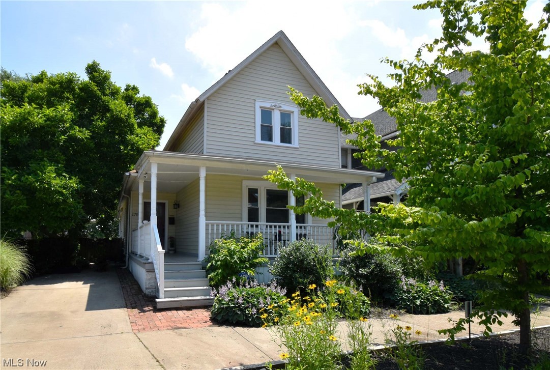 Unique, fabulous historic home, only a stones toss from the Franklin Castle! Large wrap-around front porch frames this 1900s colonial surrounded by beautiful bio-diverse local plant garden beds! Inside, stylish luxury vinyl flooring through the first floor, along with beautiful slate tile in the kitchen. Dining room features high ornate ceiling, chair rail molding, decorative baseboards, and exposed brick! Kitchen boasts soaring vaulted ceiling, ample cabinetry, granite countertops and dual sink in island! Dedicated laundry room and full bathroom off of kitchen. Two bedrooms on main floor, large back bedroom features dual closets and walks out onto lovely private patio and privacy-fenced backyard, also has potential to be used as a family/entertainment room! Upstairs, more vaulted ceilings, and 3 skylights! Owner's suite has tons of closet space! Large second full bathroom with slate tile flooring, step up shower and more! Updated electrical and vinyl windows! Prime Ohio City location
