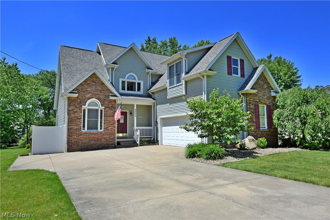 Don’t blink, this beautiful four-bedroom home isn’t going to last long! The great looks start on the outside and work their way in, filled with attention to detail and plenty of style. Gorgeous brick work accents the exterior as white trim creates sharp accents against the clean, gray siding. Out back, a massive raised rear patio creates a perfect place to dine or relax. Inside, a tall foyer opens to reveal a winding carpeted staircase. The exposed catwalk bridges the living room below as it connects the second story bedrooms and full bath. Below, the stunning living room showcases a gas fireplace and carpeted flooring. A brightly painted kitchen steals the show with its vivid looks and stepped countertops. Stainless appliances pair perfectly with the industrious eat-in dining table and stools. A formal dining room awaits opposite the kitchen. Nearby, a short hall leads to a half bath and first floor laundry. The master bedroom suite completes the floor with a spacious layout and full