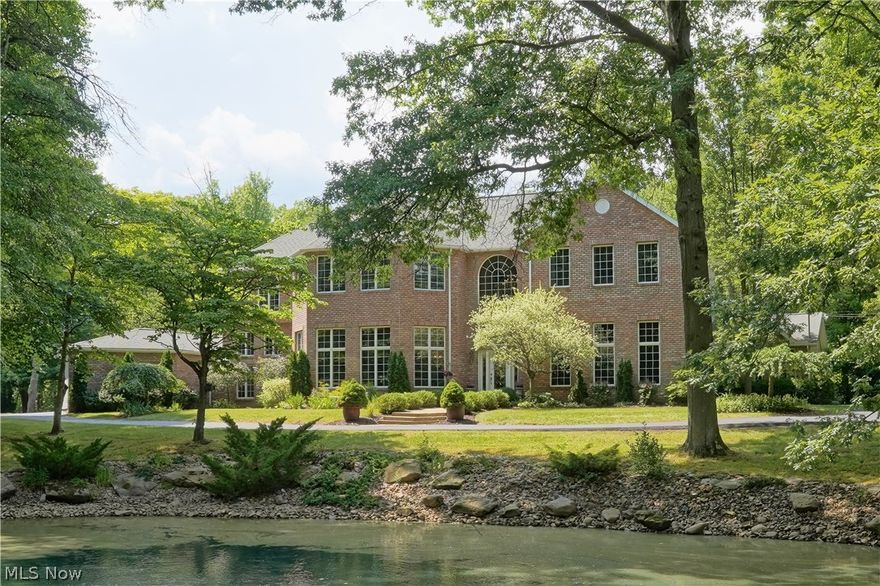 Spectacular 4 bed, 5 bath brick front colonial on 5.88 acres in Richfield Twp. Gorgeous wooded and pond views from virtually every window!  This home has been completely reconstructed w/ additions in 2002 and 2012.   Features include vaulted ceilings, extra wide hallways and staircases, walls of windows and custom finishes throughout. As you pull up the driveway you will notice the stunning koi stocked pond/waterfall. Foyer opens to first floor office/library with built ins and fantastic, spacious Great Room with double sided brick fireplace to the kitchen.  Kitchen features cherry cabinetry, granite counter tops, center island and access to the formal dining area.  A morning room/family room is a great place to enjoy your coffee and take in the serene views.  A vaulted sunroom and laundry are off the 3 car garage. Two spacious bedrooms and full bath complete the 1st floor. The expansive 2nd floor master suite features a walk-in closet and master bath with ceramic flooring, jetted tub