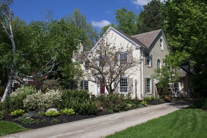 A most extraordinary Brick Colonial w/slate roof in the Club section of Shaker Heights with breathtaking custom landscaping. This home has a private, tranquil & exquisite park-like setting like no other! The integrity of this bright, sunny home has been maintained both in its original color scheme & quality updates that showcase workmanship & upgrades that will delight anyone looking for a truly classic 1930's Shaker home. Magnificent first fl Sun Room w/wet bar & walls of windows that open to outside & hot tub. Gracious LR w/marble FP  & DR w/ hardwood floors & bay window seat. 1st fl Library/Den w/built-ins & HW floors. Eat-in Kitchen w/stainless steel appliances, custom glass backsplash & French doors lead to back patio. 5 bedrooms & 3 full baths on 2nd floor. Second floor sun deck! Lower level finished Rec Rm. Other updates include newer 3 zoned A/C, nature stone fl in attached garage, cement driveway,updated electrical, ext waterproofing, sprinkler system & fully fenced yard. WOW!