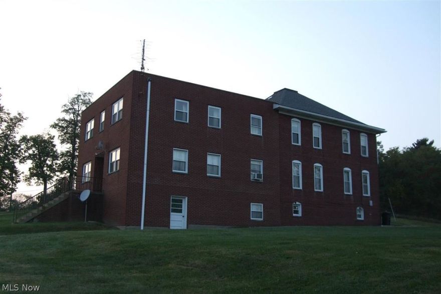 Brick 2 story structure with over 6 acres of ground. There are two kitchens, large rooms originally used as housing for clergy.  Could be converted into numerous dwellings.  2 car detached garage