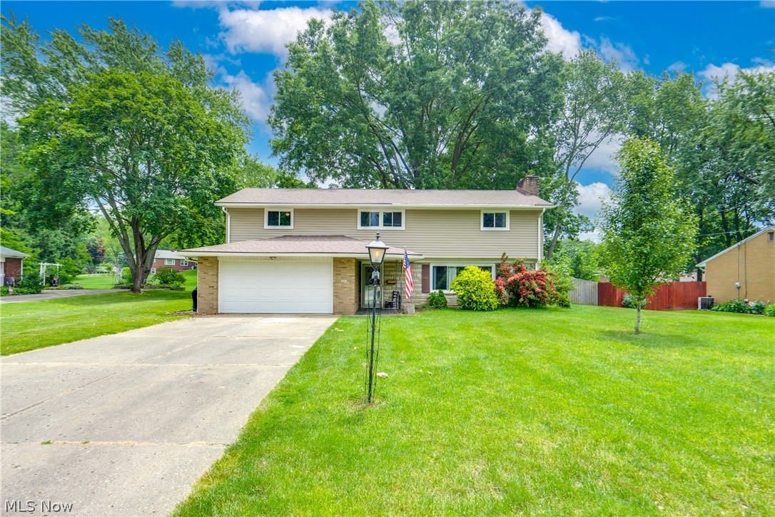 We're so excited to bring you this great home! Situated in the desirable North Canton CSD, this four-level split has four bedrooms, 2.5 baths, and over 2600 sq ft! As you step through the entryway, you'll be greeted by a spacious living room adorned with a huge window that floods the space with natural light. Get cozy by the fireplace or enjoy the built-in shelves that provide ample storage. You'll find a convenient mudroom with laundry hookups and a half bath down the hall. The family room on the second level features newer laminate flooring. The open layout flows seamlessly into the newly remodeled kitchen, which boasts great cabinet space, beautiful new quartz countertops, and room for bar stool seating. Adjacent to the kitchen is the dining room, where French doors lead you to the backyard, perfect for outdoor entertaining. The dining room also provides access to the laundry and master bedroom. The master suite has a full bath with a single vanity with cabinet space below. The third level hosts three additional bedrooms, each offering plenty of space. Completing the third level is the full bath. The full, partially finished basement provides plenty of extra storage options or potential office space. Outside, you'll find a two-car attached garage, providing ample parking and storage. The backyard features a partially fenced-in yard, and the yard is a lot bigger thanks to the second parcel. The yard extends all the way to the tree line. Additionally, a shed offers extra storage for outdoor equipment. The home is also minutes away from parks, schools, and shopping! Plus, a home warranty is provided for your buyer's peace of mind. Don't miss out! Schedule your showing today!
