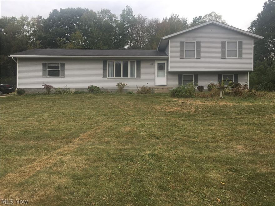 This 1994 four-level split is worth taking a look.  Offering 2048 square feet of finished living space, 3 bedroom, 2.5 bathrooms, 9x15 lower bonus room, large eat-in kitchen, living room, and comfortable family room with beautiful stone fireplace.  Located in Rootstown School System with Ravenna mailing address not too far from major highways (between Rt 44 and Rt 43).  Attached 2 1/2 car garage with water.  Good storage areas and closets, electric heat, movable kitchen wood block remains, master has own private full bath are nice features.  Plenty of room to roam inside and out on lovely 1.71 acres on quiet country dead-end road. Great quiet location!  Immediate possession offered.  Nice gardening yard too. (See broker remarks)