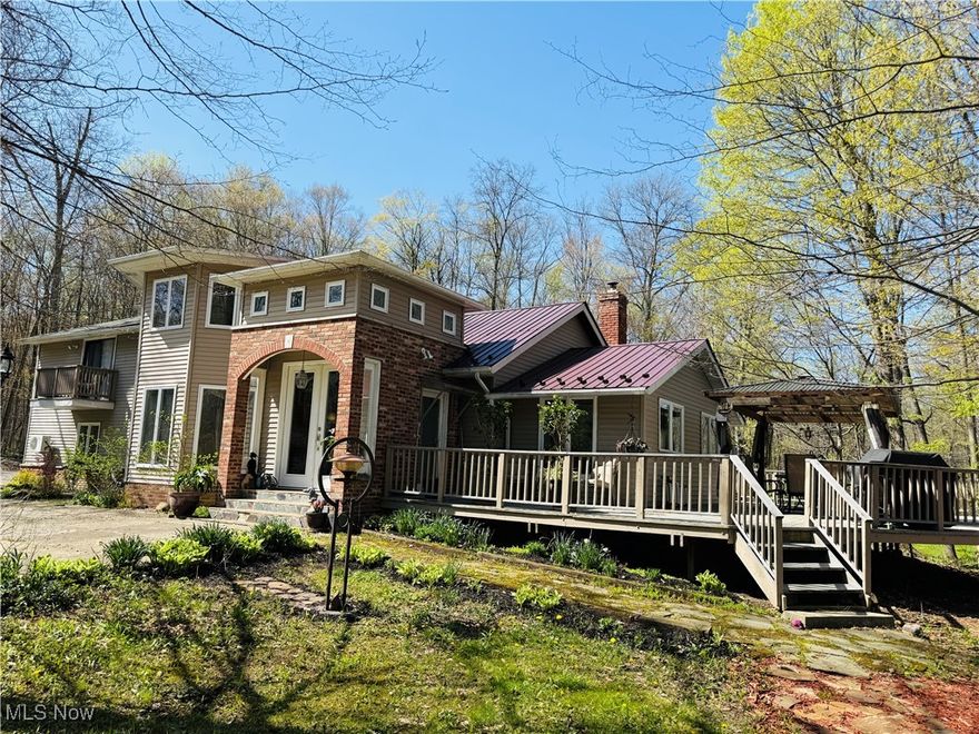 Nature Lovers Dream!!! Tucked away from everyone is this beautiful home that rests on a private cul-de-sac with a deeply majestic wooded lot on almost 6 acres in the heart of Chesterland adjacent to the Metzenbaum Park.  This property features 2 large stocked ponds, perfect for peaceful afternoons and nature watching.  This home boasts 4 bedrooms. The master bedroom has its own private steps with 2 extra large walk in closets and a balcony with a  full bathroom. You will find 2 other bedrooms upstairs and full bathroom. On the main floor is the eat in kitchen with granite countertops, wine refrigerator, fireplace and plenty of cabinets. Off the kitchen is the large dinning room for all your family gatherings. The family room has a wood fireplace for those cold winter nights.  On the first floor is a office/bedroom that leads to the sitting area and a full bathroom. Outside you will find a turn around driveway, detached 3 car garage, storage sheds and lots of gardening beds. Spend your mornings having coffee on the multi level decks overlooking your our own  private park. There is a new pool with heater for those hot summer days and a hot tub to warm up in.