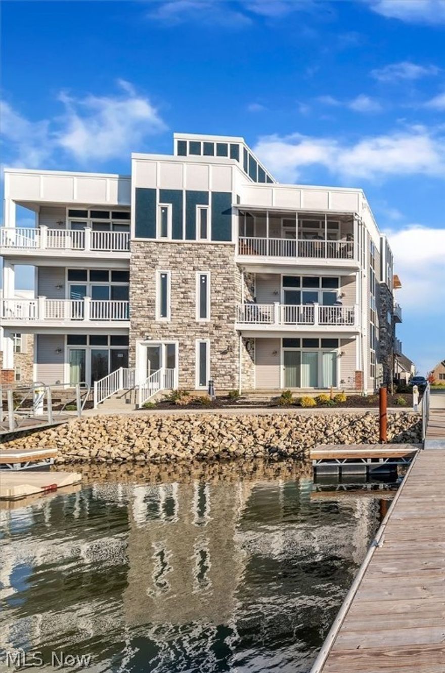 A beautiful, top floor, move in ready summer getaway home in Lakeside Marblehead with custom additions!! This freshly built condo sits within a bay front community and offers two comfortable, private balconies and a shared rooftop deck at the top of the building with water views in every direction. Your living area includes a custom built fireplace with a TV mounted above and an open screened in porch patio that sits looking out over the marina. Pre hung window treatments and mounted TVs are conveniently placed in every room as well as a mini fridge in the utility room, custom shelving, and more. All appliances in place and ready to use, including a gas stove

As a bonus, you have the option to include a 40' boat dock that is just steps away. There is is a bay front clubhouse, inground pool, beach patios, live weekend events, and even more amenities! Come take a look!