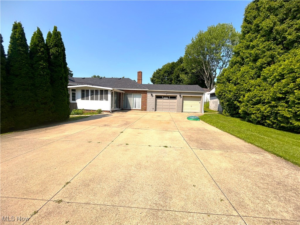 This is an amazing and one-of-a-kind properties with a private backyard oasis and a retreat-like living. Across from the Barberton Hospital and a short distance to Giant Eagle grocery, this must-see property is the perfect home for you! You must see an oversized private drive and a private patio surrounded by sprawling and tall pine trees that will make you feel like you are on the California coast! Enjoy your private garden area extra shed and storage area, as well as the spacious 2 car garages! Slider door entry way leads you to a spacious mudroom. Eat-in kitchen features a wall of windows, spacious counter space, quality oak wood kitchen and attractive high gloss flooring. A must-see Master Suite with its own slider to a private patio area. Other 2 bedrooms are conveniently located next to a Living room, inviting plenty of natural light. There is a front door entry and a mud room entry way. You will love this luxurious bathroom with remodeled ceramic shower and a massage shower head. The bathroom also features a nice ceramic tile flooring, new vanity, lighting and mirror. Enjoy this fully finished basement with recess lighting, excellent for celebrating birthdays! You will love this separate "gym room". A convenient lower level 1/2 bathroom is nicely updated, while a large Laundry Room is fully carpeted and it features a tub shower. Schedule your appointment today to see in person this very unique and beautiful property. Roof, windows and all appliances are newer (5+ years).