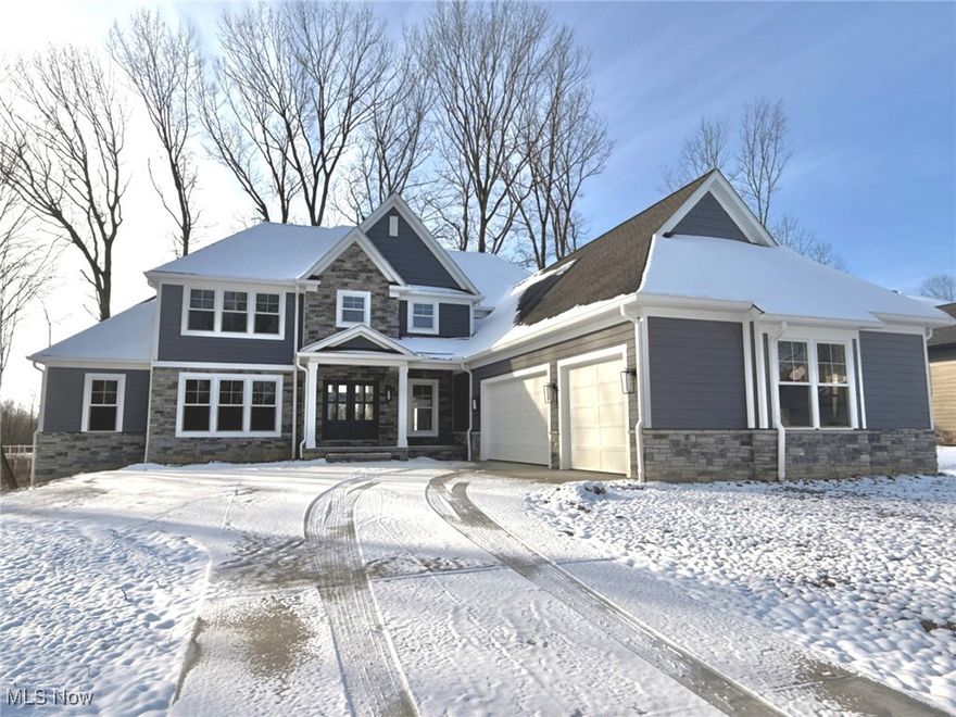 Simcon Homes delivers a show-stopping new spec home that perfectly blends timeless craftsmanship with modern sophistication. Move-in ready, this exceptional residence is just waiting for the buyer’s final carpet selections. Thoughtfully designed for today’s lifestyle, the open floor plan is elevated by refined architectural detail and designer-inspired finishes throughout. The striking exterior combines stone and Hardie Plank with on-trend color selections, creating instant curb appeal. Inside, a dramatic two-story foyer makes a grand first impression. Just off the entry, a beautifully detailed home office provides an ideal space for remote work. The expansive great room features a stunning rear wall of windows that fills the space with natural light and flows seamlessly into the gourmet kitchen and dining area—perfect for entertaining. The kitchen impresses with a large center island with seating, abundant cabinetry and counter space, premium appliances, and an oversized walk-in pantry. The adjacent dining area opens to a covered composite deck, extending your living space outdoors. Luxury vinyl plank flooring spans the main level, including the spacious mudroom with built-ins and an oversized laundry room offering extensive cabinetry and work space. The main-level owner’s suite is a private retreat, highlighted by a tray ceiling with custom wood ceiling, spa-like bath with dual vanities, makeup counter, oversized custom tile shower, and a generous walk-in closet. Upstairs, three spacious bedrooms include one with a private ensuite and two connected by a Jack-and-Jill bath with separate vanity areas. All bedrooms feature walk-in closets. Enjoy the coveted Barrington lifestyle with access to golf, racquet sports, swimming, and exclusive club amenities. Builder offering a $25,000 credit toward landscaping, basement finish, or closing costs.