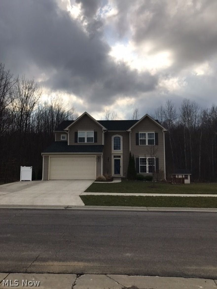 This beautiful home is truly move in ready. Great 2 story foyer leads to open concept great room with gas fireplace, kitchen with optional gourmet island and seating, sitting room/breakfast nook with beautiful wall of windows and formal dining room. First floor also has laundry and powder room. Upstairs has a huge master with additional sitting area and large master bath. 3 more nice sized bedrooms and a large full bath complete the upstairs. Majority of the lower level is finished with an optional extension to the great/family room. The outdoors has a huge deck, large patio, plenty of green space and a creek. The wetlands behind the home are owned by the homeowners association and cannot be developed. Matching outbuilding/shed for storage. The 2 car attached garage is clean and spacious, the driveway has room for 3 cars. Furnace, AC and over sized 80 gallon water tank  are all only about 5 years old. Located in Whispering Woods development, a charming location right around the corner