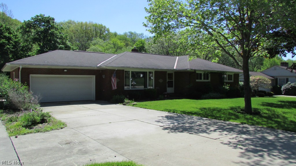 Welcome to this wonderful and spacious 3 bedroom brick ranch in Stow. This home has hardwood floors throughout the first floor, 600+ finished square feet downstairs lower level, Newer furnace and A/C in 2010, updated windows, waterproofed basement with transferrable warranty, attached 2 car garage, extra driveway and parking area. This home is located 4 houses away from a wonderful Metroparks bike/hike trail that leads to Munroe Falls. The highlight of this property is the very large open backyard and back concrete covered patio with wonderful views of the creek in the distance at the edge of the property. Seller calls this "Little Piece of Heaven" you should come take a look for yourself, a must see.