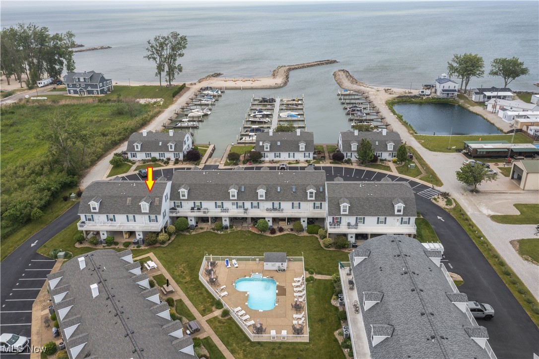 Live the lake life at Spinnaker Bay in Port Clinton! This beautiful 2-bedroom, 2-bath condo is being sold turn-key, fully furnished and decorated - just bring your bags! Enjoy stunning pool views from your elevated deck and Lake Erie & Marina views from your carport patio. Recent updates include a new furnace, A/C, and water heater (2020) for worry-free living. The enormous laundry room previously had bunk beds for additional sleeping space. A 35' boat dock is included, making it perfect for boaters. Plus, enjoy the private beach for ultimate relaxation. Don't miss this waterfront gem - schedule your showing today!