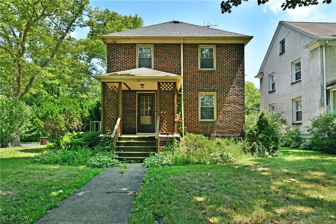 All brick construction and three floors of potential living space, what more can you ask for? Is it move-in-ready? Sure is. Welcome to this fantastic McDonald home, ready and waiting for you to make it your own! Take a closer look as you explore this impressive residence, beginning with its great location on a quiet, corner lot that allows for easy access to the detached two car garage. The cement driveway widens to create a rear patio space, just steps from the rear entryway. An additional side entrance is available while the formal covered porch faces the street. Through the front door, a spacious living room gives a hint of what’s to come. Thick wood trim work is deeply stained to contrast the bright walls and carpeted flooring. The main stairway rises from the far side of the room. Meanwhile, the formal dining area showcases hardwood style flooring and built-in casework. The accompanying kitchen delights with marbled, stone-look countertops and a robust footprint. At the second floor, three sizeable bedrooms branch from the hall. Draw a bubble bath in the clawfoot tub, found inside the deep-set bathroom. A hidden staircase leads up to the third-floor bonus room, easily doubling as office space. Laundry and storage are located at the basement level.