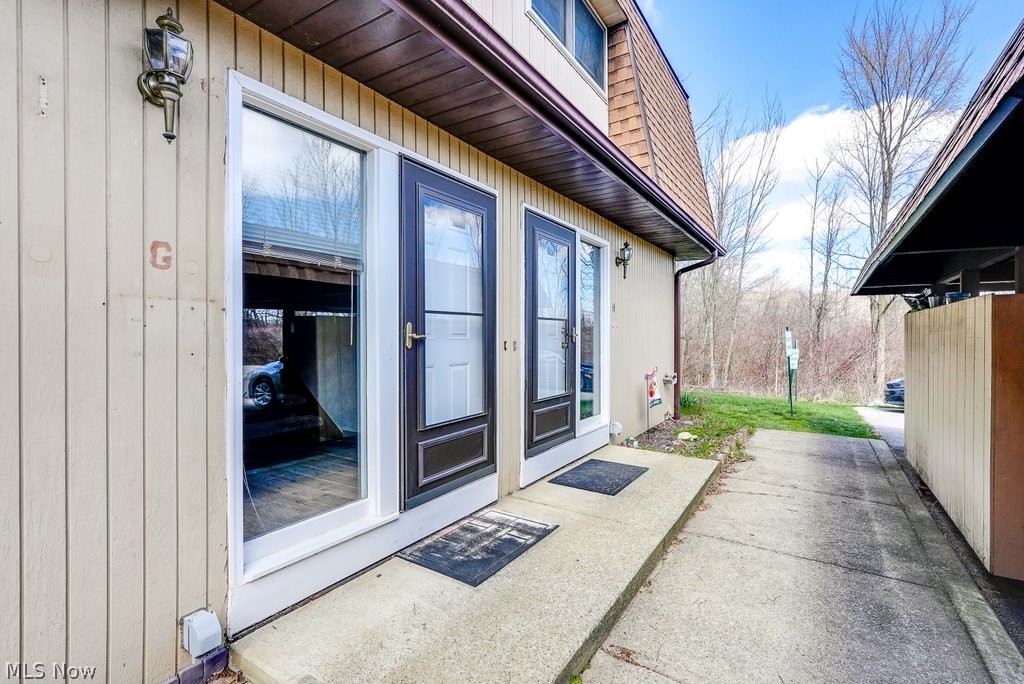 Looking to downsize, to find an affordable alternative to on-campus housing, or seeking a sound investment opportunity then don’t miss this lovingly maintained townhouse nestled in the Meadow Creek Condominiums community! This 2 Bedroom, 1.5 Bathroom unit offers comfortable and convenient living just minutes from Kent State University and downtown Kent. Step inside to the foyer with its beautiful wood-look ceramic floors and well-placed half bath. The kitchen comes fully equipped with a dishwasher, garbage disposal, microwave, range, and refrigerator. Enjoy meals in the carpeted dining and living room area adjacent to the kitchen, which features a sliding glass door leading to a cement patio with a SunSetter awning perfect for enjoying sunny days overlooking the creek or entertaining guests. Head upstairs to two spacious bedrooms boasting newer carpeting (replaced within the past four years), with the master bedroom offering a large walk-in closet for all your storage needs. The updated bathroom features a sun tunnel to brighten the space and a convenient walk-in shower that was added by the owners. This unit stands out with its rare feature of having a washer and dryer conveniently located in the full unfinished basement, which also boasts a cedar closet, a shelving unit, a large cabinet, and additional storage space under the steps. Parking is a breeze with 2 assigned spaces, including one under a carport right outside the door, complete with a storage cabinet. Rest easy knowing that major updates have already completed, including a roof replacement in 2013, furnace and air conditioner servicing in 2023, and a newer hot water heater installed in 2019. Plus, double-pane windows on the second floor installed in 2020 enhance energy efficiency and comfort. Enjoy easy access to dining, shopping, and entertainment options. Don't miss out on this opportunity! Schedule your showing today!