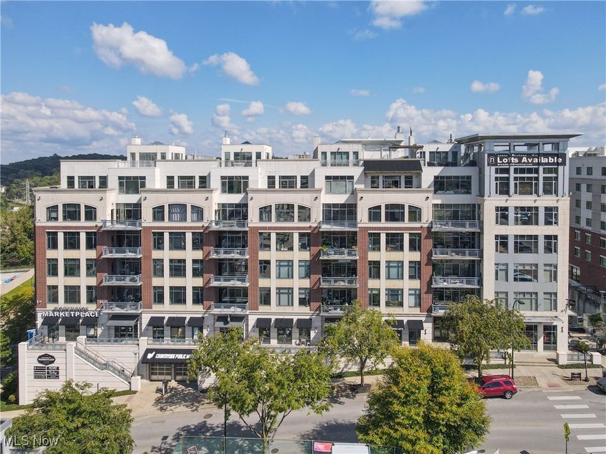 This immaculate 3 bedroom, 2 bath condo encompasses all the amazing features related to Northside Lofts: spectacular views, functional floor plan, upscale finishes, impeccable style and maintenance free living! The entryway blends industrial and modern with brick columns and wall lighting to create a nice gallery hallway displaying your colorful artwork. Located on the southeast corner, this unit has walls of virtually floor to ceiling windows and a 21' x 10' balcony. Quartz and stainless counters in the kitchen with atrium light, stainless appliances, and two-level bar seating for five. Spacious great room with brick walls, exposed duct work and concrete ceilings, an entertainment wall with a 3-burner bio-ethanol fuel fireplace. The master bedroom has access to the balcony and a separate sitting room/work out area. The master closet is ample and functional with stackable washer/dryer and adjustable shelving throughout. The master bath is magnificent with two white glass vessel sinks and a custom tile shower with a downtown view. Second bedroom is set with overhead lighting and pendant lighting over nightstands. Double doors lend to a third bedroom / home office with views north and east. Enjoy the amenities of Northside including: fitness room, conference room, heated & secured garage parking, resident limo, concierge