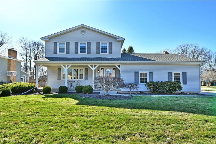 A must-see Poland residence offering three floors of finished living space and a fantastic location within a desirable neighborhood. Set on a prominent corner lot, the home showcases impressive curb appeal, beginning with a relaxing covered front porch perfect for warm spring days and continuing to an elaborate rear patio complete with a nearby raised storage shed and charming cottage-style mini outbuilding. Additional highlights include a heated garage with Nature Stone flooring, conveniently located at the end of the cement drive with a side street entrance. Step through the front door to find the main staircase rising from the welcoming foyer. The expansive living room features hardwood-style flooring and tall lattice windows that flood the space with natural light. A formal dining room follows with backyard views and an elegant blown-glass light fixture complemented by raised panel wainscoting. Prepare your favorite meals with ease in the impressively sized kitchen, featuring ample counter space and warm wood cabinetry. Casual eat-in dining awaits nearby as ceramic tile flooring flows underfoot past the garage and basement entrances before reaching a charming half bath. The rear family room completes the main level with patio access, a striking brick fireplace, and built-in bookshelves with storage. Upstairs, a spacious updated full bath offers dual vanities and a beautifully tiled shower. Three inviting bedrooms branch from the landing, each featuring soft carpeting and generous closet space. The partially finished basement adds even more versatility with a bonus room and laundry area. Additional features include a newer roof, vinyl replacement windows, all appliances stay, and a one-year home warranty.