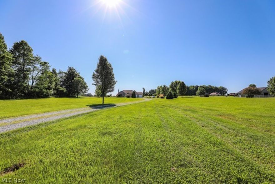 Welcome home to 12569 Nelson Parkman Road is Garrettsville, OH. This 2988 square foot Ranch style home is situated on 6.88 acres in beautiful Nelson Township. The main floor living area consists of: an in law suite with private access, a designated sitting area with French doors, bedroom, and private full bath. Additionally there is a formal dining room with built in wet bar; large great room with wood burning fire place; open concept eat in kitchen with center island and dining area; and sunroom with access to the large wrap around wood deck. The master bedroom with en suite bath features dual walk in closets (8x8 & 8x12) dual vanities, shower and garden tub. There is second bedroom with a large closet, additional full bath; and first floor laundry. The huge full unfinished basement features an additional bedroom, new electric furnace (4 y/o), water softener system, BRAND NEW 80 gal H2O tank, two sump pumps, two electric panels, an egress fire escape window and has been plumbed for an additionall bath. This basement could be easily finished off and would provide tons of extra living space. Exterior features include an attached three car garage with electric and 220 line, back covered porch area, wrap around wood deck and an above ground pool. Schedule your private showing today to see everything this house and 7 acres has to offer!