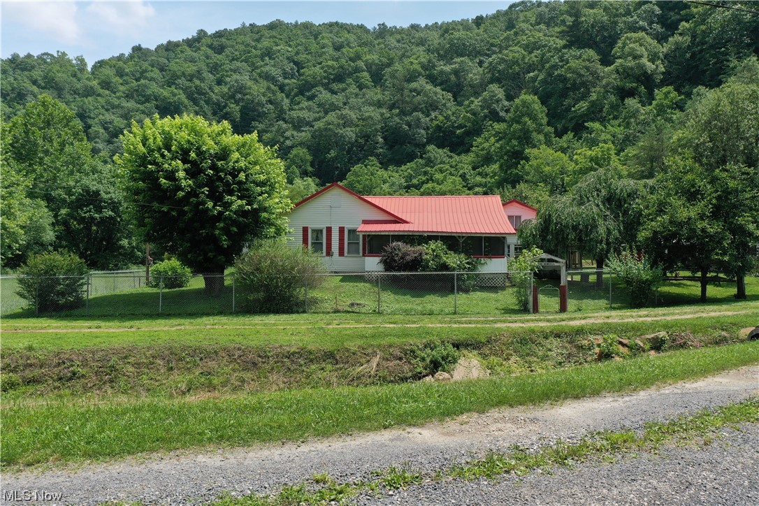 Ready to homestead or develop a hunting camp? This farm is packed with potential. Situated on 69 acres +/- this home is a blank canvas waiting for your creative touch. Timber valued over $25k! Utilities include FREE NATURAL GAS, multiple water wells, septic, and electricity. The house itself currently features 4 bedrooms, 2 bathrooms, living room, dinning room, kitchen and a cellar. While it does need work, this property presents an excellent opportunity to create your dream camp or start from scratch and build the home you've always wanted. Numerous outbuildings, including a garage, carports, and a barn, offer plenty of space for storage, tools, and equipment. The fruit trees, berry patches and garden spaces are already fenced in and ready to feed your family! The property also boasts a big pond, adding to its natural charm. However, it's important to note that the location is in the 100-year flood plain, due to its proximity to the riverfront. There is a bridge for everyday travel ac