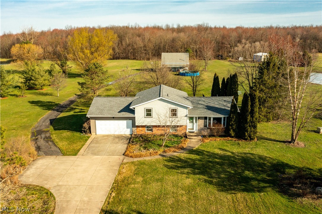 ***OPEN HOUSE SUNDAY 3/24 12-2PM*** Welcome to this charming 4 Bedroom, 2.5 bathroom split-level home on 7 acres in Columbia Station! With many great updates cosmetically and mechanically, this well maintained home is sure to impress inside and out! As you enter the home, you will be greeted by beautiful hardwood flooring that flows throughout the main level. The kitchen was remodeled with high end cabinetry, Corian countertops and stainless steel appliances, including a double wall oven and separate cooktop! The eat in kitchen also provides access to the newly reconstructed deck that overlooks the gorgeous landscape. The bright, cozy living room finishes the main level. On the lower level you will find a large family room with a gas fireplace and access to the 2 car attached garage. A bedroom with an attached half bathroom completes the lower level. The basement features a large rec room and an additional full bathroom. There is plenty of storage space in the laundry area as well. Upstairs you will find 3 bedrooms and an updated bathroom with a heated whirlpool tub! Moving outside, the country living begins! You'll fall in the love with the massive 36x36 two story outbuilding with concrete floors, electricity, water, a gas heater, a wood burning stove, a phone line and a cable line! A wooden deck extends an additional 10 ft from the barn with an overhang to create a front porch! A partially fenced in yard with locking gates keeps the precious cargo safe! The property extends well into the woods, about 1,000 ft. Enjoy country living with easy access to amenities! Roof approximately 2019, Furnace and AC 2011, Hot Water Tank 2023, Windows replaced 2000-2010. One Year Home Warranty included!
