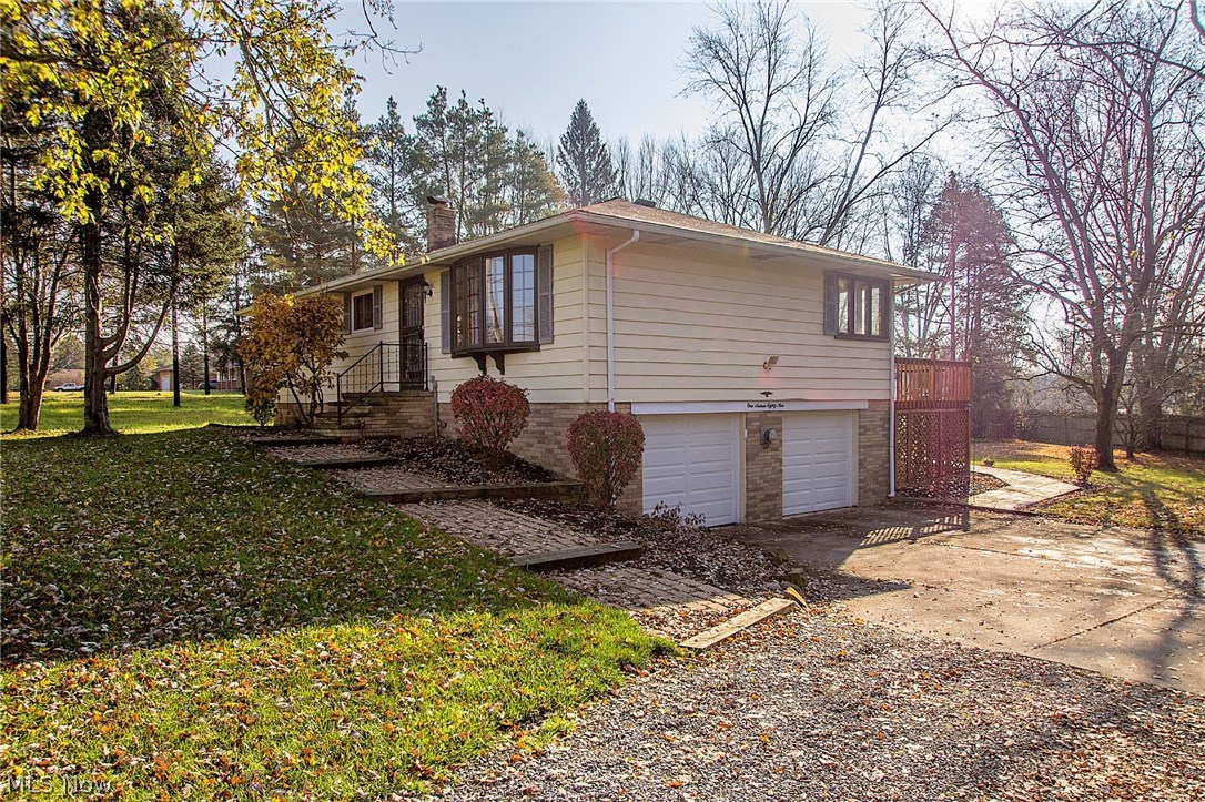 Welcome home to this beautiful 3 bedroom ranch where one can enjoy the hardwood floors throughout the kitchen and all 3 bedrooms! This gorgeous home also includes an updated bar with a built in electric mini-refrigerator, which is conveniently located in the fully finished basement! Also located next to the bar is an electric fireplace, which can also be used as a wood burning fireplace! Other updates include a heated garage, built in blinds in the kitchen, a shower in the basement (along with 1 full and 1 half bath upstairs on the main level), updated full bath, new windows in October of 2014, furnace in 2009, new garage door in the Spring of 2009, a complete roof tear off in January of 2008, glass block windows in the basement, a partial privacy fence in the semi-wooded back yard, a back porch, and septic/aeration system rebuilt in January of 2015! Gas lines are also installed behind the oven and dryer should you want to convert to gas!