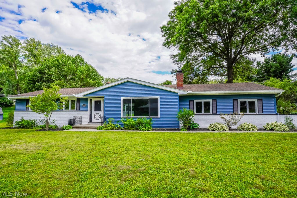 Enjoy ranch living at its best in this beautifully updated Springfield Township home on nearly an acre! The layout suits buyers just starting out or those with a growing family. The living room features a cozy wood-burning fireplace with a brick surround, decorative tile accent, and a big picture window. Vinyl plank flooring flows into the stunning kitchen, which boasts new granite countertops, a tile backsplash, stainless steel appliances, and a dining area with a charming built-in cabinet and a sliding door leading to the covered deck and patio. Nearby, the combination laundry room and mudroom provide access to the attached three-car garage. Down the hall are three nicely sized bedrooms and two remodeled full baths. The master suite includes a double closet and a private bath with a tiled step-in shower, while the secondary bedrooms share a new bath with twin vanities and a tub/shower. Relax in the lower-level rec room with space for games and a sitting area with another wood-burning fireplace. The fourth bedroom is perfect for guests or a home office. Outside, enjoy the manicured landscaping and the peaceful backyard lined with mature trees. Recent improvements include a new furnace, A/C, hot water tank, and two garage doors. Schedule your showing before this one is gone!