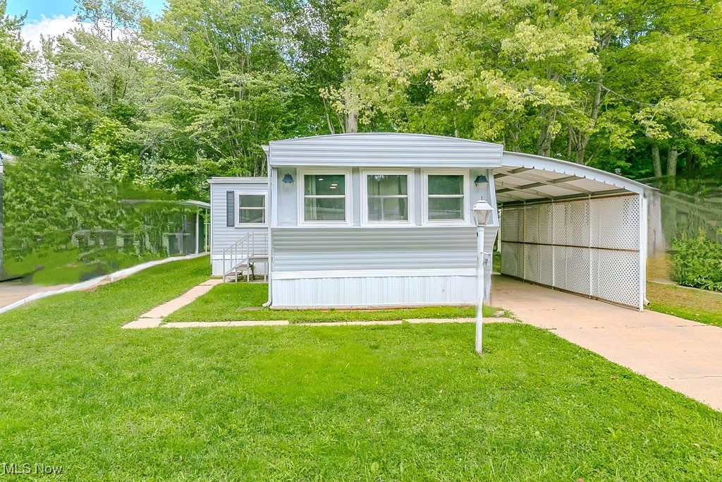 Welcome home to easy, quiet, 55+ community living in Normandy Village. Step into this spacious home that offers 2 generously sized Bedrooms and 1.5 Baths. Enjoy the Open floor plan with sprawling Living Room, Dining Room, and generous Kitchen. Many updates including: New Roof, Windows, gutters, vapor barrier, HWT, & flooring. The entire home has been overhauled since purchase, including living room drywall replaced. Owner added carport, lattice, patio slide door, painted the outside, installed new ADA toilet in bath, and installed new plumbing/heat traced & insulated(plug on side of home)from kitchen to half bath. Shed comes with the property. Washer new 2024, Dryer 2019. New front and side doors (storm and main 2023.) Come make this one-floor easy-living home in an EXCELLENT community YOURS today!
