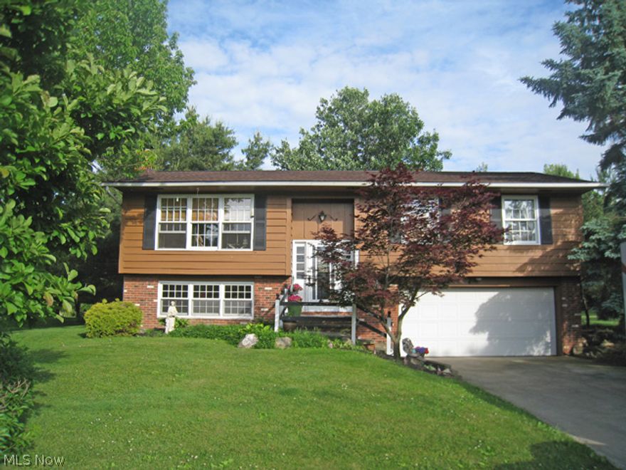 Fabulous 4 bedroom, 2 full bath bi-level situated on over one-half acre!  This immaculate home offers a large country kitchen with a sliding door that leads to the private deck, a main bath, a living room, and 3 bedrooms on the main level.  The lower level offers a family room with a wood burner fireplace, a full bath, a 4th bedroom or an office, laundry room, & extra storage.  A 2-car attached garage is located off this level. Recent updates include: roof, furnace, & C/A. Completing this offering is a private, park-like yard. a spacious dog kennel, a barn/shed, and has public sewers.  Enjoy the newly built library, YMCA, and the excellent rated North Royalton schools!