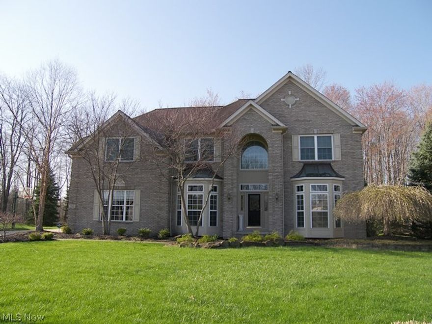 Move Right in!  Spacious colonial on private, wooded cul-de-sac lot.  Formal living room and dining room with decorative pillars and office on first floor (could be 5th bedroom with full bath nearby).  Open great room and kitchen with soaring ceiling and gas fireplace.  Upgraded kitchen with amazing counter space, breakfast bar, Espresso cabinets, granite counters, stainless appliances (including, side by side fridge, double convection ovens, center island cooktop and microwave drawer),  and slider to the freshly stained deck (04/15) and paver patio.  Oversized master with vaulted ceiling, glamour bath and amazing closet.  Three additional bedrooms with closet organizers and full bath on second.  Nicely finished lower level provides additional living space, exercise room, pre-plumbed for kitchen area and full bath, utility room with sink and great storage.  First floor laundry room and an amazing 3 car garage with storage wing lined with shelving.  Beautiful wooded lot with designated