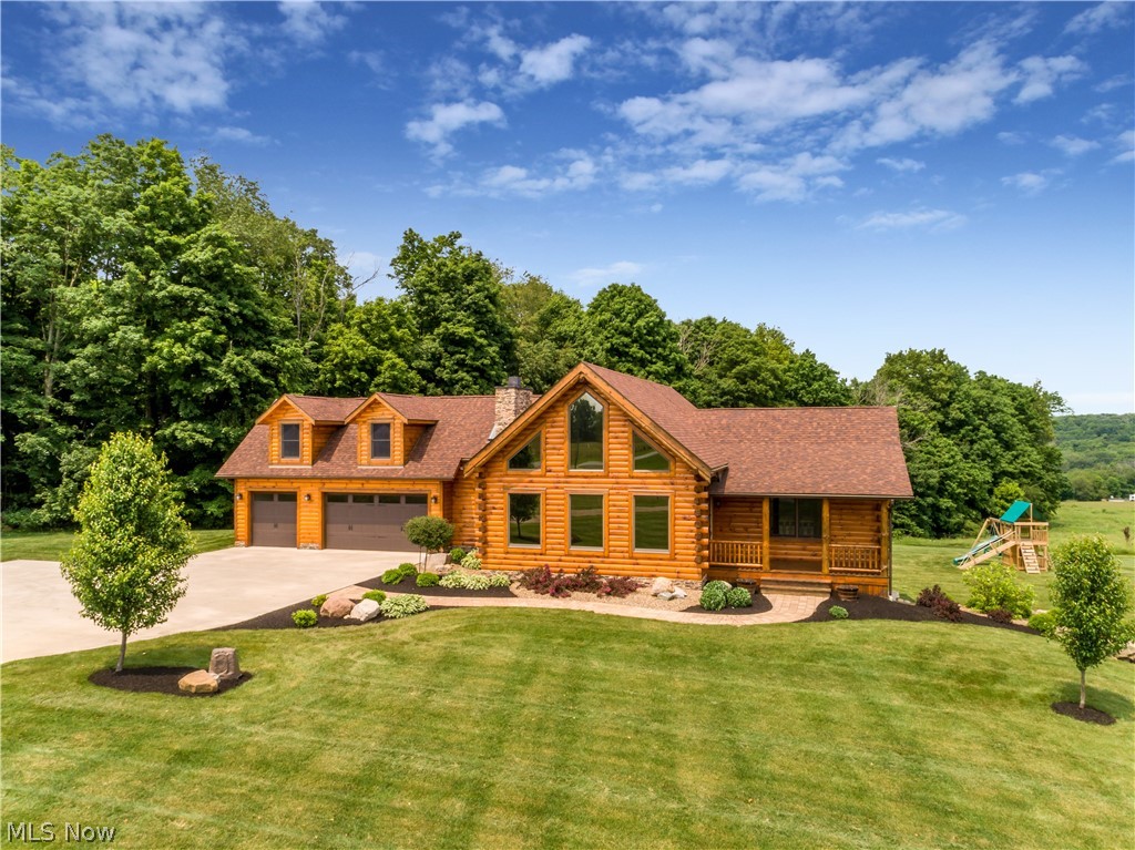 Welcome home to this stunning custom-built log home in North Lawrence. Upon entering, a spacious great room with wood burning fireplace and cathedral ceilings can be found. The open floor plan makes it perfect for family gatherings and entertaining. The dream kitchen has granite countertops, hickory cabinetry, and stainless-steel appliances. Home is complete with a first-floor master that is spacious, private, and has a walk in closet and full bathroom. Along with the first-floor master bedroom, there’s added convenience with a first-floor laundry and half bath for guests, this is single floor living at its finest! Heading upstairs gives you bonus living space, including an impressive loft that overlooks the great room. Office and bonus room over the garage adds a retreat for any visitors joining you in your scenic cabin getaway! If this wasn’t enough, walkout basement is finished with large family room, 2 bedrooms, full bathroom, and tons of storage space. Head through the walk ou
