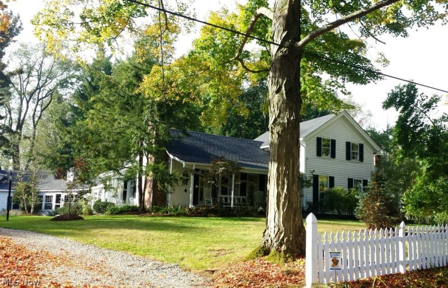 Western Reserve Century Farmhouse, built in 1870 which is both well maintained and restored.  On one of the most picturesque streets in Geauga County, it has retained its charm including lots of the original Chestnut floors; 9' ceilings; plaster walls and a quaint breezeway for a morning coffee. First floor master bedroom suite with a working fireplace, remodeled kitchen with granite counters, Tulip wood cabinets, open bar to the family room, a pantry featuring plenty of cabinets, a second oven, soapstone counter and a microwave,  a Buck wood stove fireplace insert which can heat the major living areas,  This is a 3 to 4 bedroom, 4 full updated beautiful baths home. It has been featured in Country Living and Victorian magazines. Many updates in the past 2 years include a new roof, gutters, basement waterproofing, two new hot water tanks, updated electrical sub panels, first floor laundry, most rooms freshly painted. The property is a magical 2.03 acres with 3 separate perennial gardens